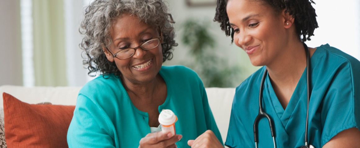 Nurse helping lady with medication