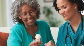 Nurse Helping Lady With Medication
